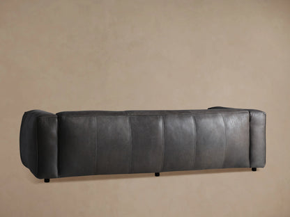 Detailed close-up of the Madrone Leather Sofa's dark charcoal grey distressed leather upholstery with visible stitching and piping.