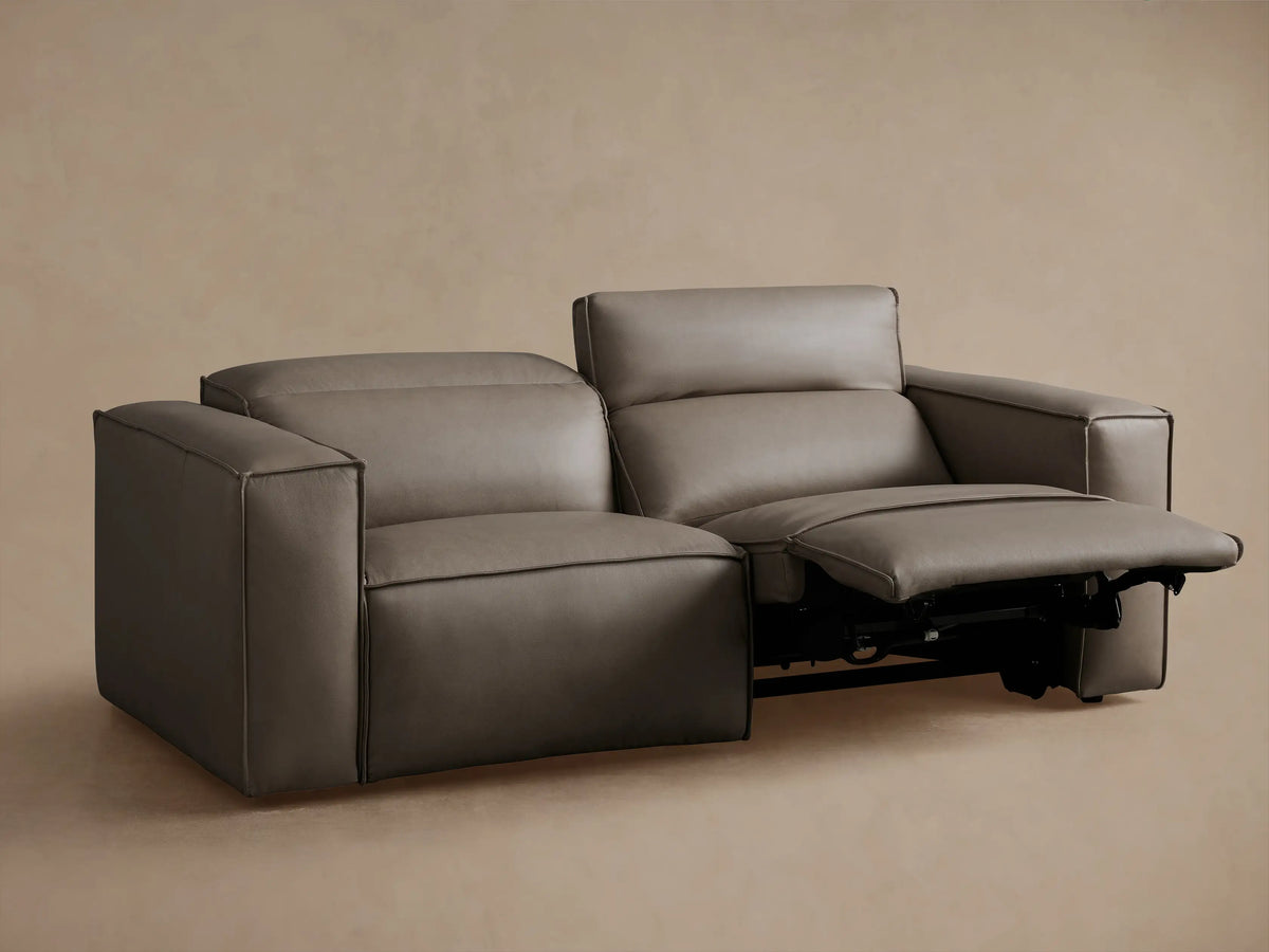Coburn Leather Two-Piece Motion Sofa in gray leather with one recliner extended, showcasing its sleek, modern design.