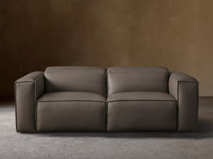 Coburn Leather Two-Piece Motion Sofa in rich brown leather with smooth, boxy arms, plush cushions, and reclining sections on a wood floor.