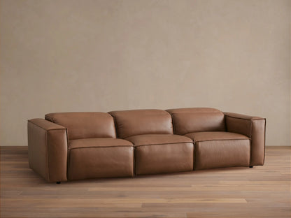 Coburn Leather Three-Piece Motion Sofa in brown leather finish, featuring three recliners with armrests on ends, positioned in a bright room.