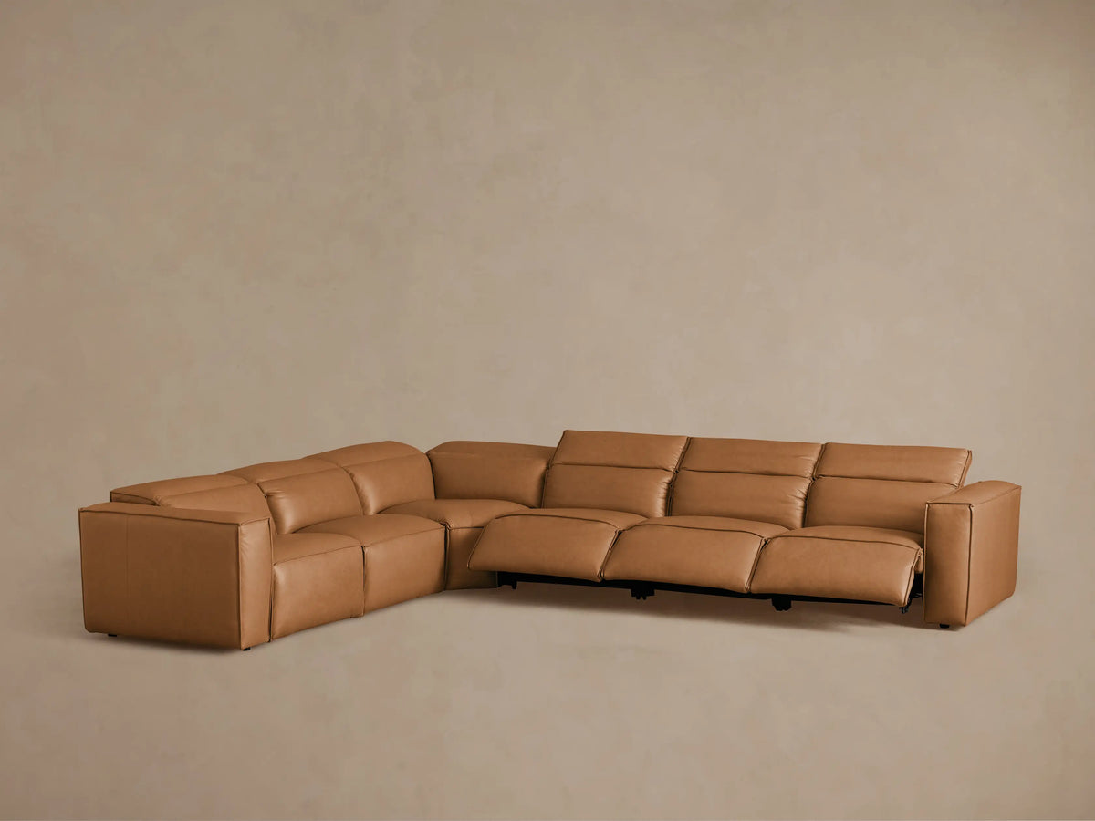 Coburn Leather Six Piece Motion Sectional in brown, shown from a rear angle, highlighting its smooth leather and recliner sections.