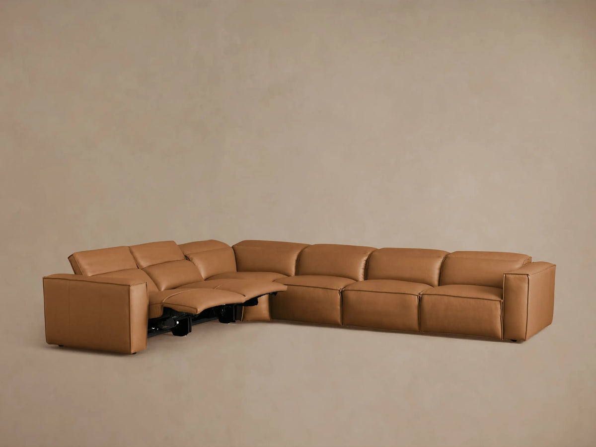 Coburn Leather Six Piece Motion Sectional in soft tan, featuring recliners and plush cushions, arranged in an L-shape.