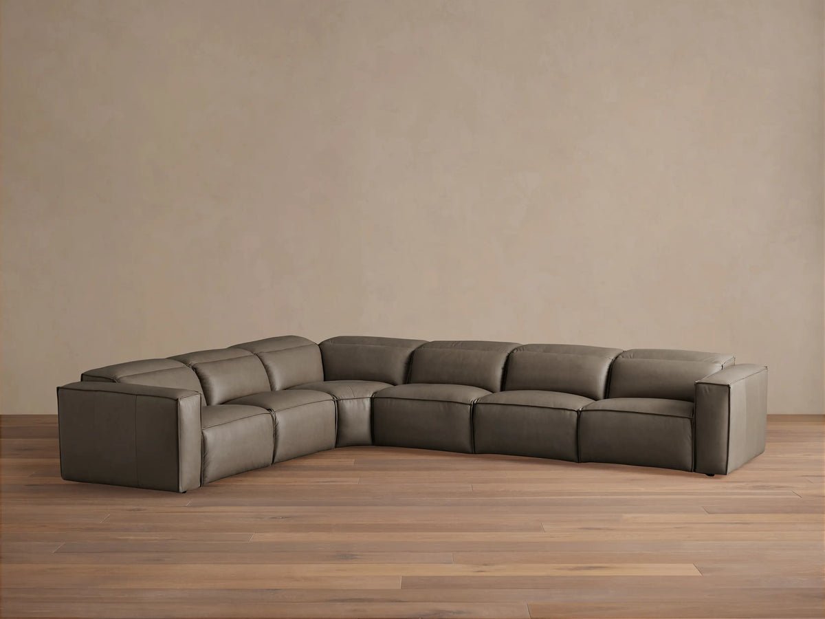 Coburn Leather Six Piece Motion Sectional in gray leather with plush cushions, left arm recliner, and right arm recliner, on wooden floor.