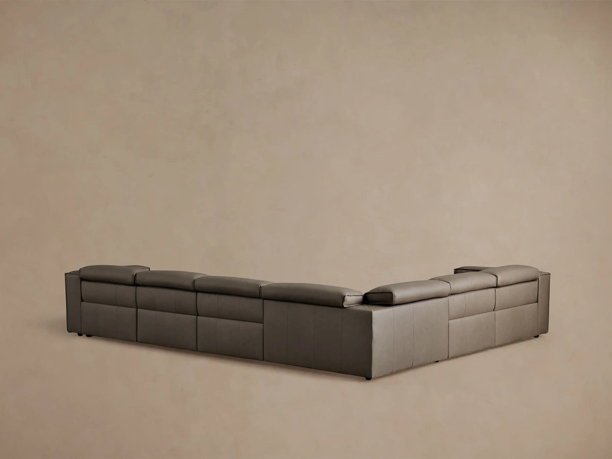 Coburn Leather Six Piece Motion Sectional in dark brown leather, showcasing one recliner partially extended, with plush cushions.