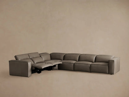 Coburn Leather Six Piece Motion Sectional in brown leather, shown from the back at a slight angle. The sectional is in an L-shape with visible smooth seams.