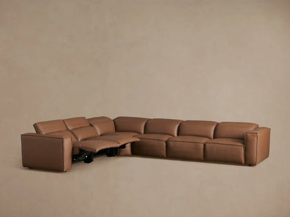 Coburn Leather Six Piece Motion Sectional in a warm brown color, L-shaped arrangement, viewed from the back and side, highlighting sleek, buttery leather texture.