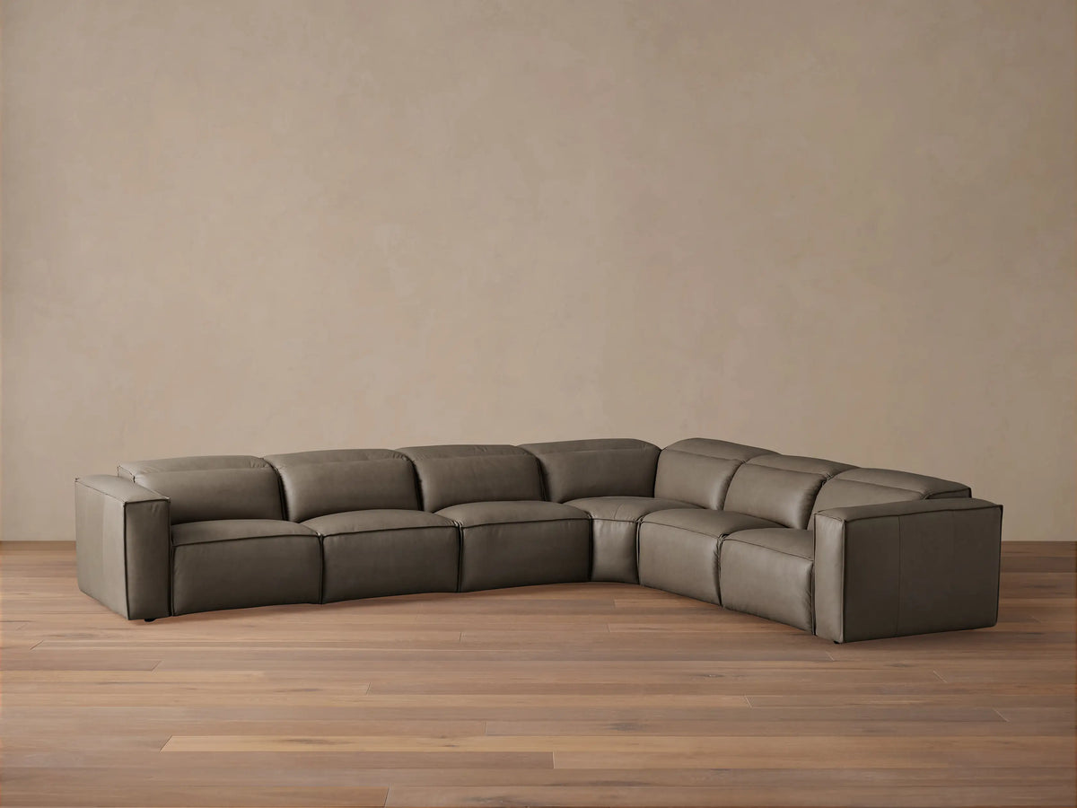 Coburn Leather Six Piece Motion Sectional in dark brown leather with clean lines. Long horizontal layout, left and right arm recliners, armless sections, and a corner piece on wood floor.