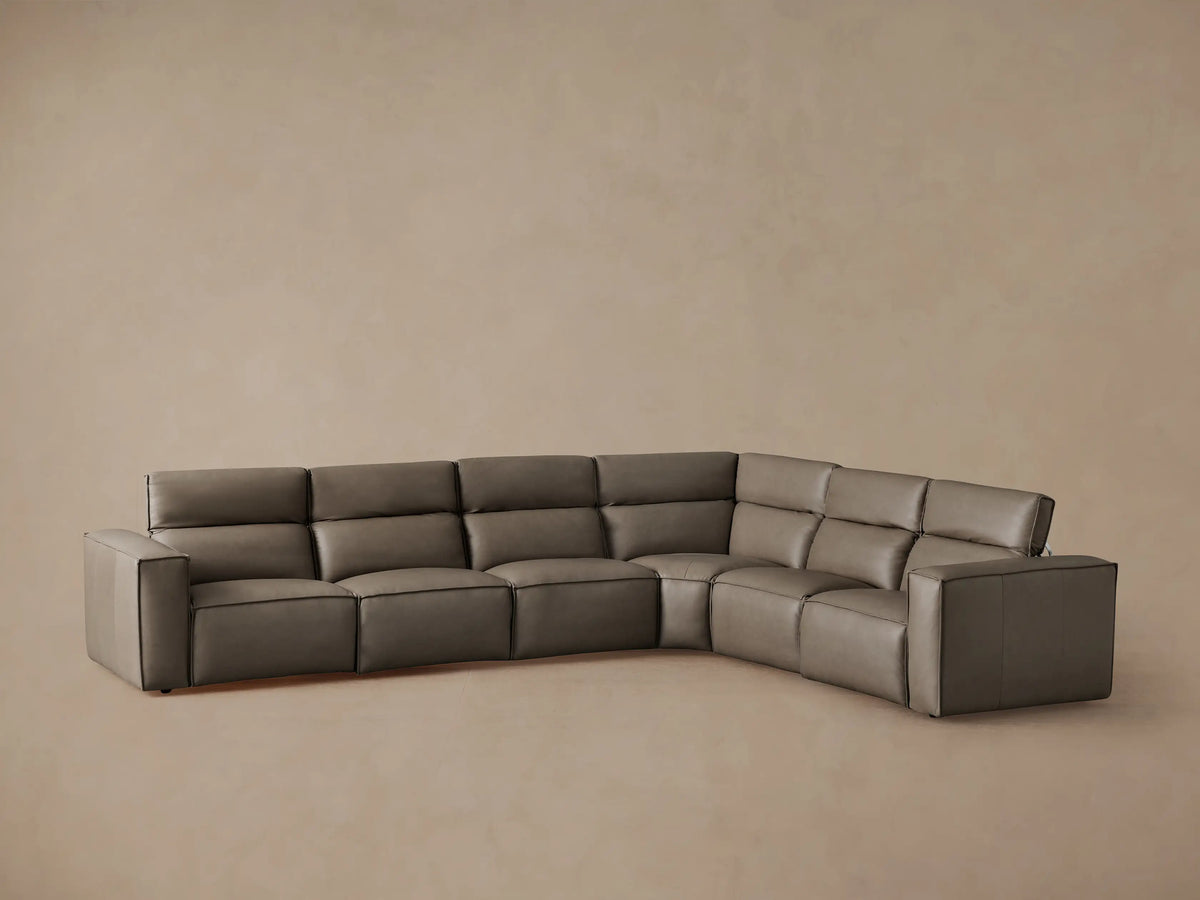 Coburn Leather Six Piece Motion Sectional in gray, featuring reclined seats and plush cushioning, set against a neutral background.