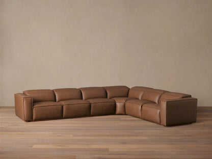 Brown leather six-piece Coburn sectional on a wooden floor. Includes left and right arm recliners and non-reclining corner. Backdrop is neutral.
