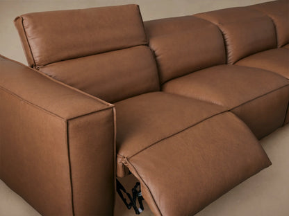Alt text: Brown leather Coburn sectional sofa with six reclinable pieces arranged in an L-shape on a wooden floor against a beige wall.