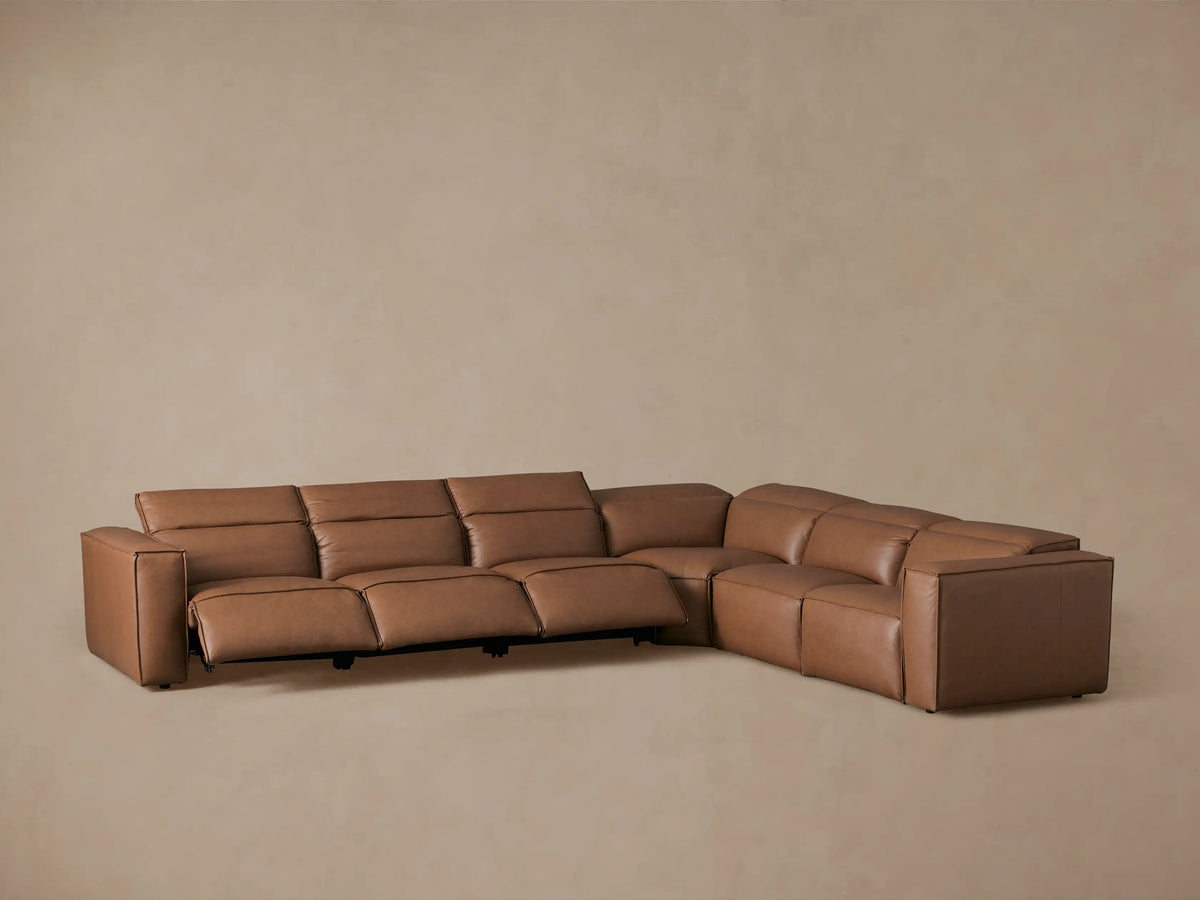 Coburn Leather Six Piece Motion Sectional in warm brown leather, L-shaped arrangement, smooth surface, and minimalistic design.