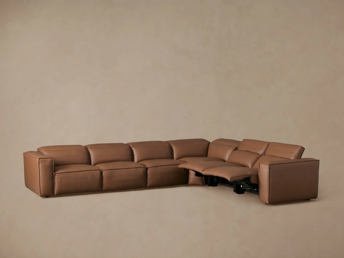 Coburn Leather Six Piece Motion Sectional in brown leather, featuring a reclined left section, corner unit, and right section, set against a plain background.