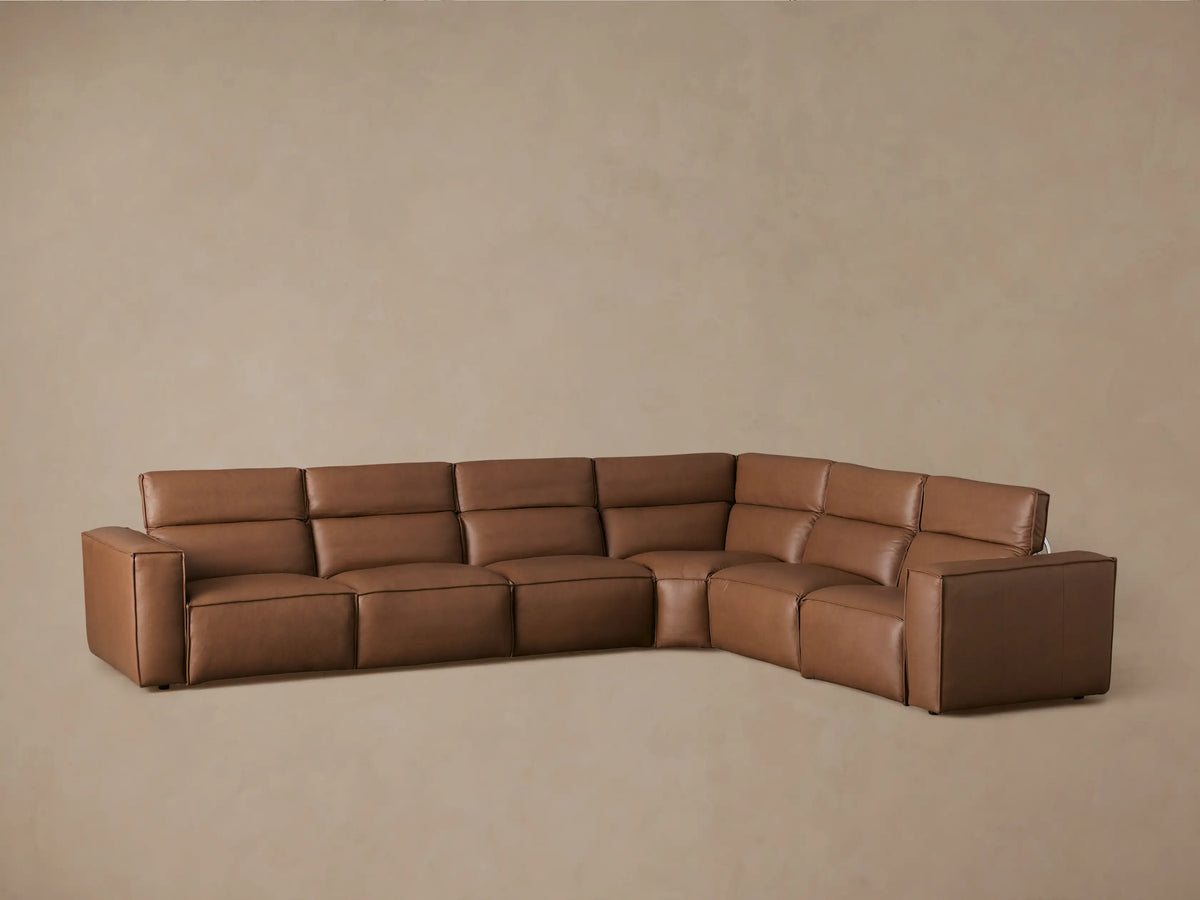 Coburn Leather Six Piece Motion Sectional in brown leather; includes recliners and corner piece; one footrest extended; beige background.