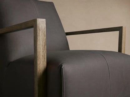 Walsh Leather Glider in dark brown leather with a high back, square wooden armrests, and a round swivel base on wood floor.