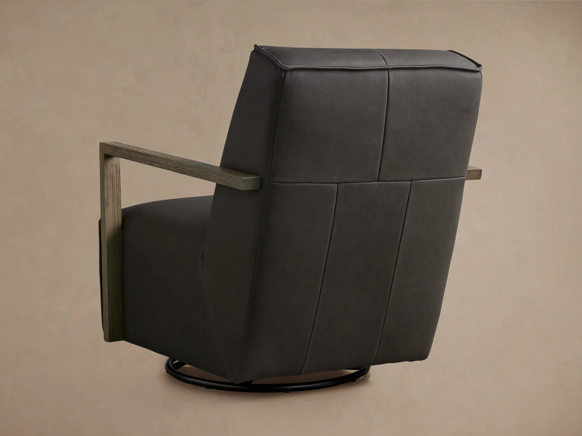 Walsh Leather Glider in dark brown leather featuring a sleek profile with wooden armrests and a swivel base on a neutral background.