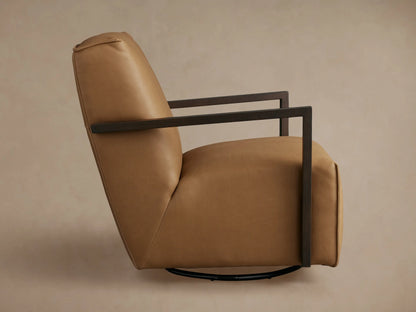 Tan leather Walsh Glider chair, seen from the back, featuring dark armrests and a circular black swivel base.
