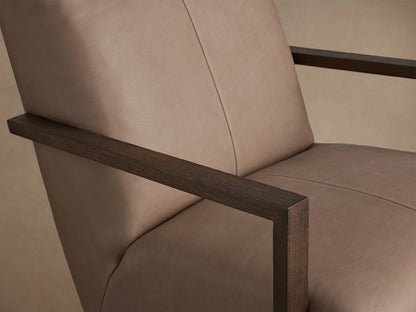Walsh Leather Glider, a modern taupe leather armchair with dark hardwood open arms, on a black swivel base, front view.