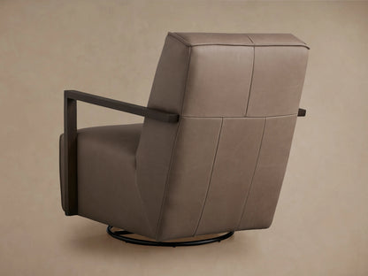 Front view of Walsh Leather Glider, light brown leather with dark wooden arms, on a black swivel base. Against a tan wall & wood floor.