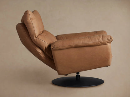 Deacon Leather Swivel Recliner: Tan leather chair with plush cushions, viewed from its left side, on a round black swivel base.