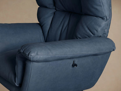 Front view of a plush Deacon blue leather swivel recliner with padded back and rolled armrests, on a black round base, wood floor.