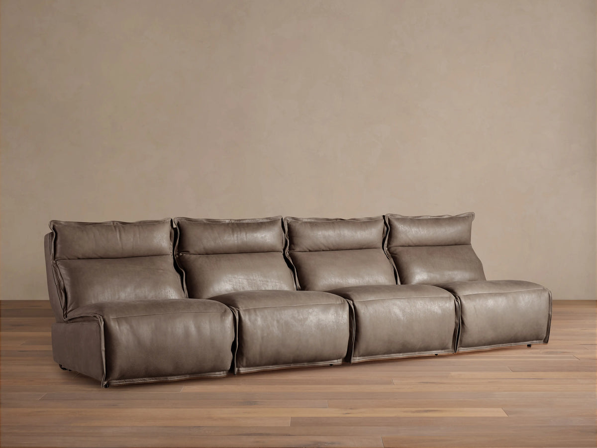 Rowland Leather Four-Piece Armless Motion Modular Sofa in brown leather, shown in a cozy living room, featuring four armless recliners.