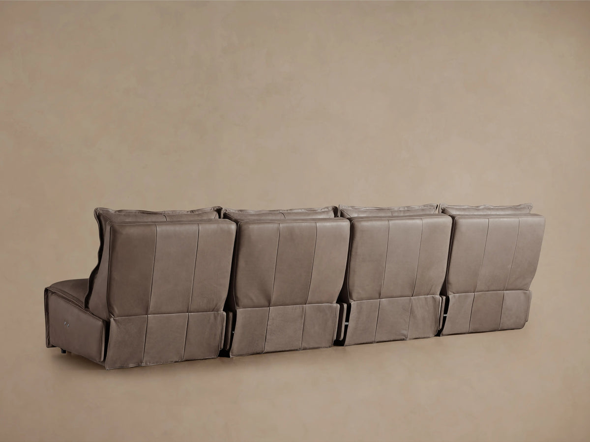 Close-up of the Rowland Leather Modular Sofa, showcasing its smooth, textured brown leather backrest and soft cushioning.