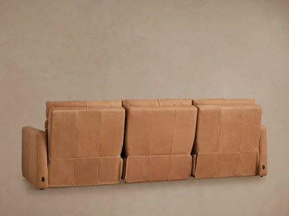 Close-up of a Rowland Tailored Leather Modular Sofa, showing its warm brown leather, tailored stitching, and armrest.