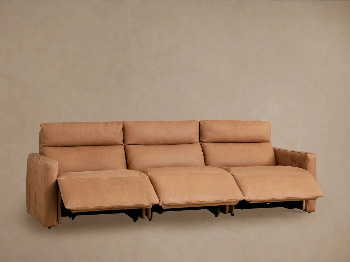 Rear view of a tan Rowland Tailored Leather Three-Piece Motion Modular Sofa, showcasing its three individual recliner units.