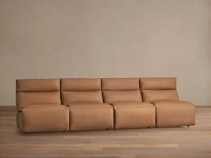 Full view of Rowland Tailored Leather 4-piece armless motion sofa in camel leather on wood floor, against beige wall.