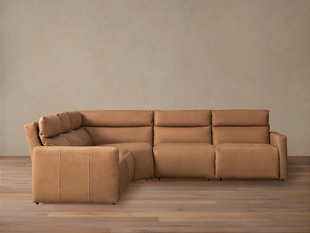 Rowland Tailored light brown leather 5-piece motion corner sectional sofa with padded backrests on a wood floor.