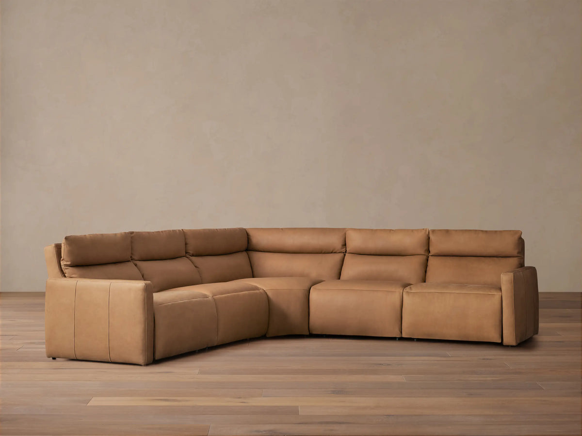 Brown Rowland Tailored Leather Five-Piece Motion Corner Sectional with an extended recliner in a stylish living room setting.