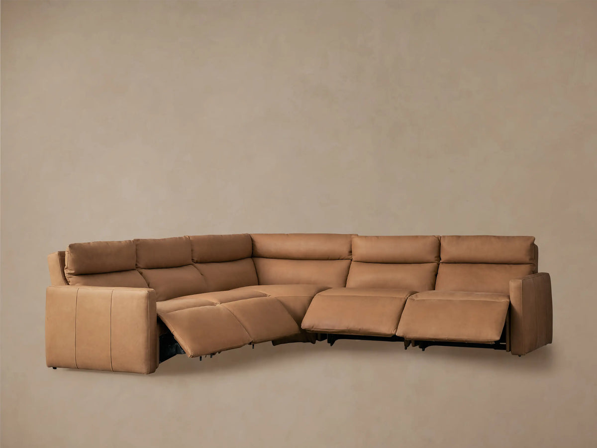 Rear view of a light brown Rowland Tailored Leather Five-Piece Motion Corner Sectional, showing its L-shape and sleek design.
