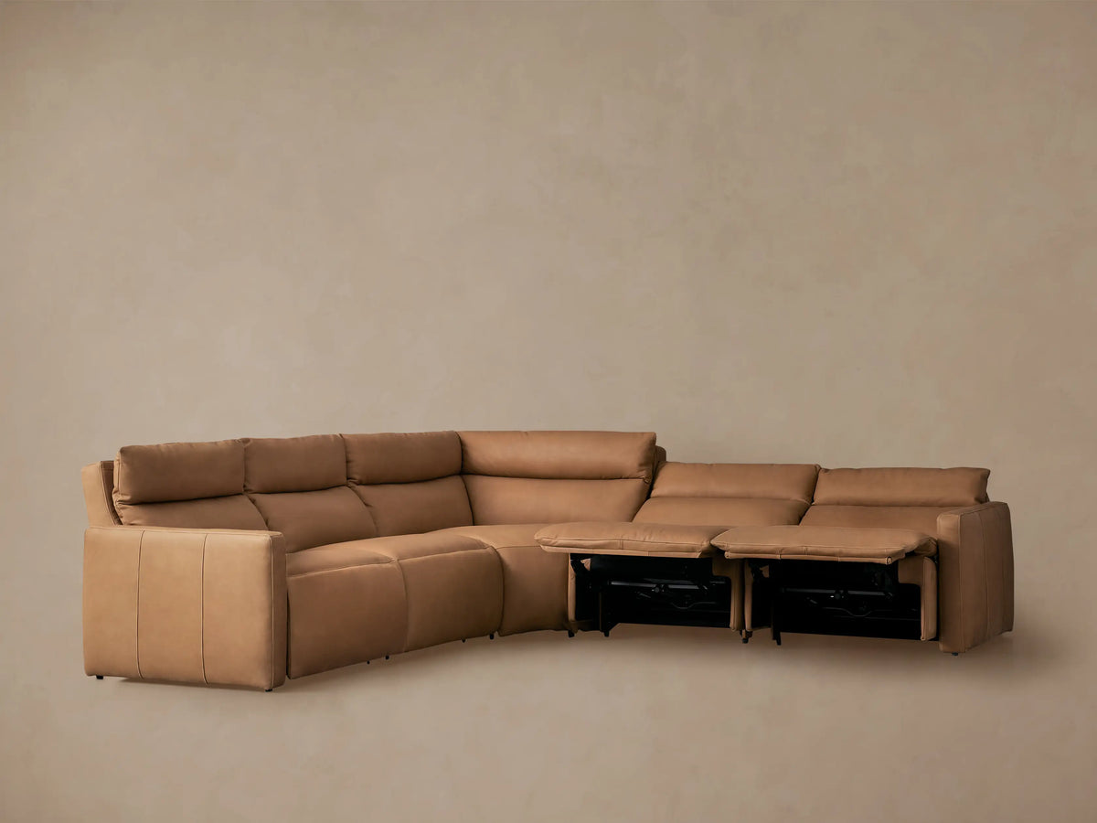 Rowland Tailored tan leather 5-piece motion corner sectional with two footrests extended, on a neutral background.