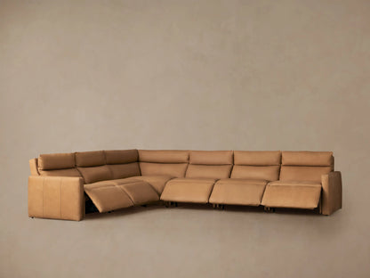 Warm tan leather Rowland Tailored L-shaped six-piece motion sectional sofa on a wooden floor against a beige wall.