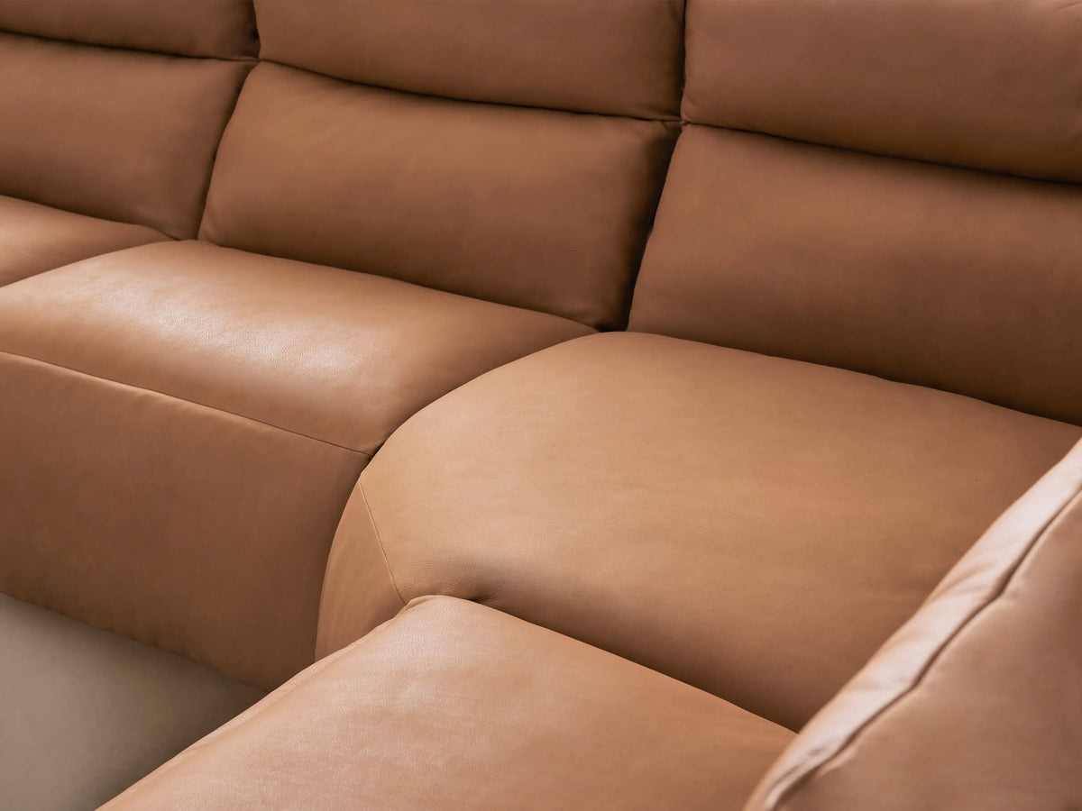 Rowland Tailored Leather Six-Piece Motion Sectional, L-shaped, light brown, with several of its motion footrests extended.
