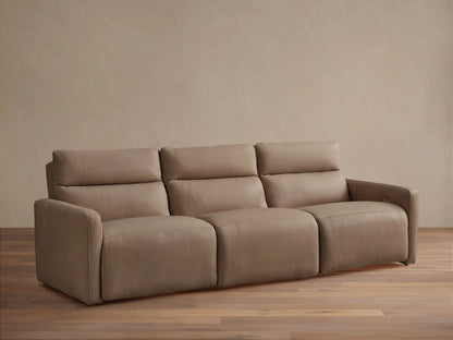 Front view of a Rowland tailored three-piece motion modular sofa in light brown leather on a wood floor.