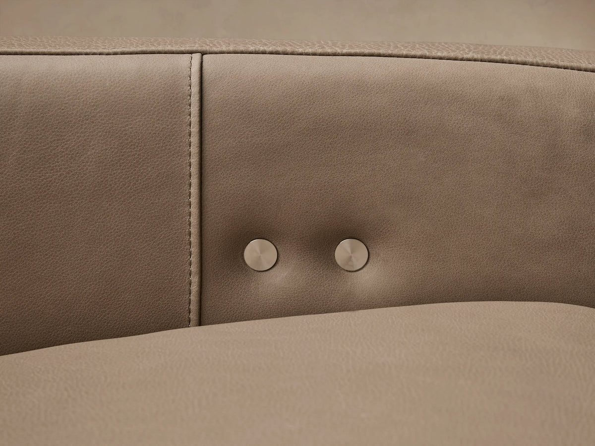 Rowland Tailored Leather Three-Piece Motion Modular Sofa in light taupe, angled on a wooden floor against a neutral wall.