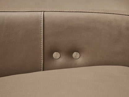 Rowland Tailored Leather Three-Piece Motion Modular Sofa in light taupe, angled on a wooden floor against a neutral wall.