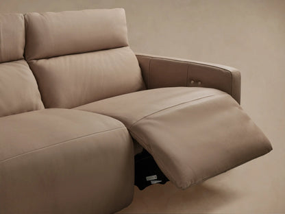 Close-up: Rowland Modular Sofa's tan leather backrest & seat with vertical stitch, featuring two silver motion control buttons.
