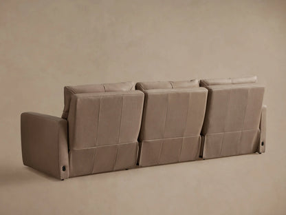Close-up of a light beige Rowland Tailored Leather Motion Modular Sofa with an extended footrest, showcasing the recliner feature.