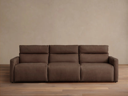 Dark brown tailored leather Rowland 3-piece motion modular sofa, front view, against a light beige wall and wood floor.