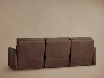 Close-up of a rich brown Rowland Tailored Leather Modular Sofa, showing an armrest, seat, and back cushion with visible stitching.