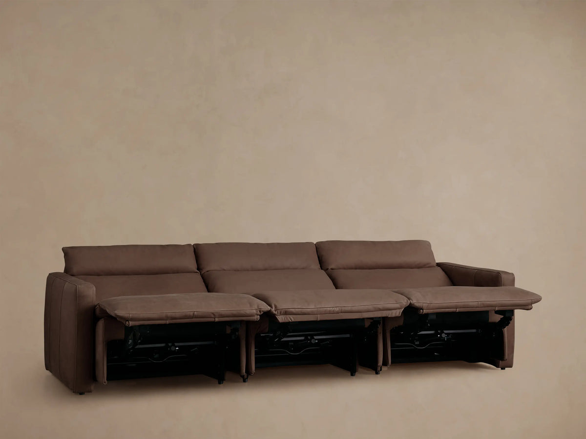 Rowland Tailored Leather Three-Piece Motion Modular Sofa, dark brown, with all three reclining footrests extended.