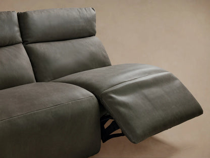 Rowland Tailored 4-piece charcoal leather armless modular sofa. Leftmost section reclined, others upright, on wood floor.