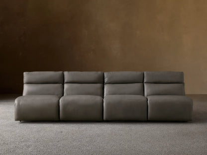 Rowland Tailored charcoal gray leather four-piece armless modular sofa on a wooden floor, against a light brown wall.
