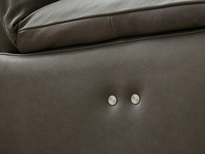 Close-up of an ebony leather Rowland Armless Motion Modular Sofa section, reclined with extended footrest.