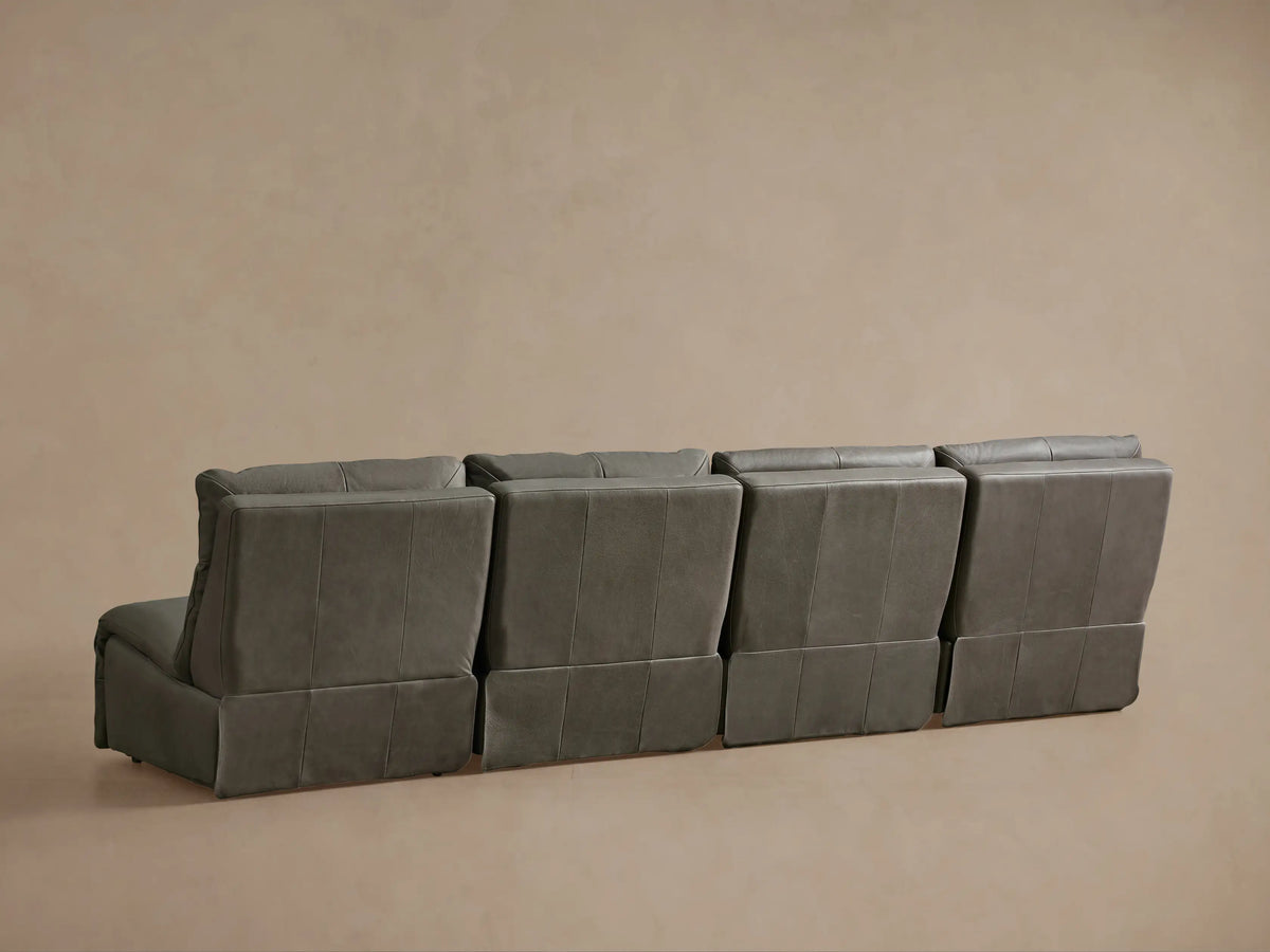 Rowland Tailored Leather Sofa, dark grey with a visible seam and two round silver control buttons.