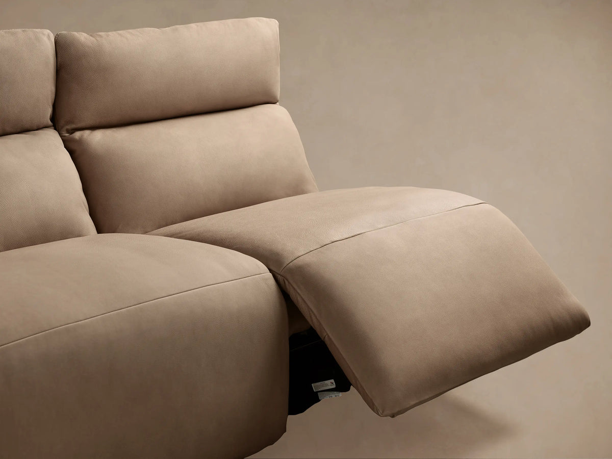 Close-up of Rowland Tailored Leather Modular Sofa's rich taupe leather texture and two silver motion control buttons.