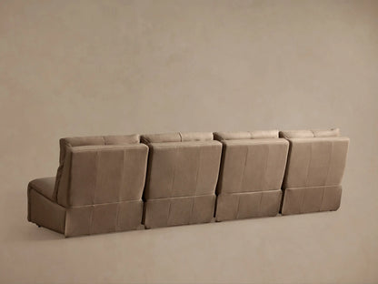 Close-up of a light beige leather Rowland Armless Motion Modular Sofa section with footrest extended & backrest reclined.