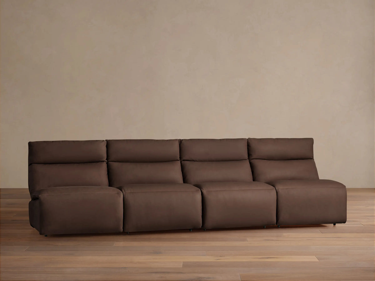 Rowland Tailored Leather Four-Piece Armless Modular Sofa in dark brown, plush and tailored, on a wood floor.